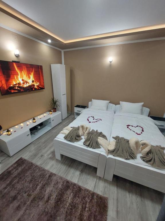 a bedroom with a large bed with a fireplace at Stan na Dan Jovanovic in Valjevo