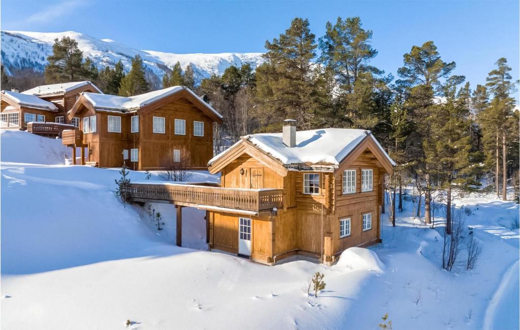 a log home in the snow at 3 Bedroom Nice Home In Hovet in Hovet