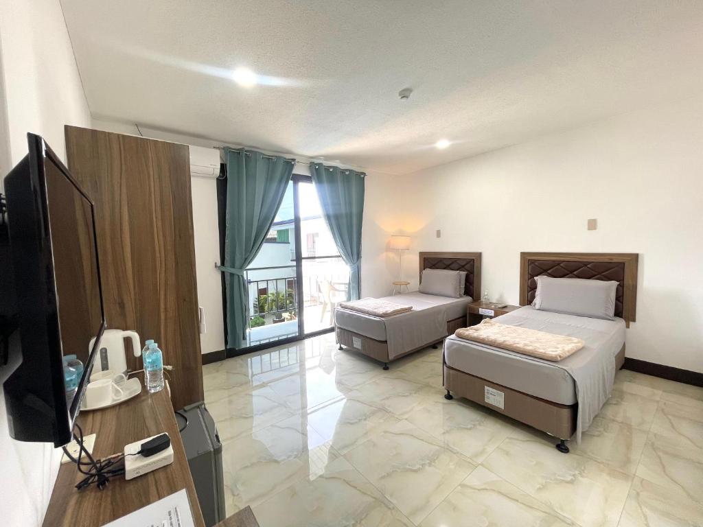 Postel nebo postele na pokoji v ubytování MGH Alona Resort