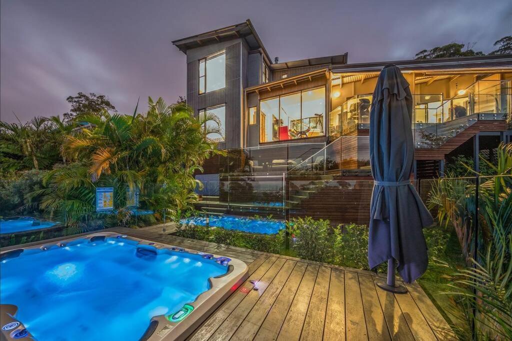 an exterior view of a house with a swimming pool at Coastline: Alpine Villa in Mount Tamborine