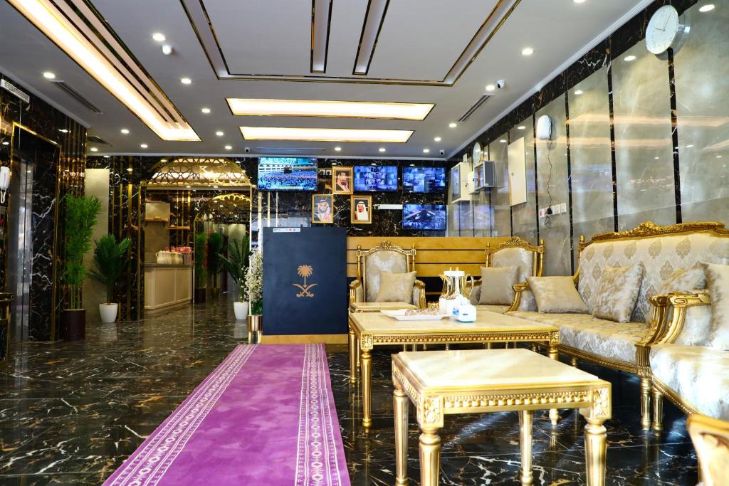 a lobby with couches and tables in a room at فندق منازل الضيف in Al Madinah