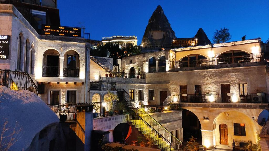 an old building with lights on it at night at Elegance Cave Suites & Restaurant in Goreme