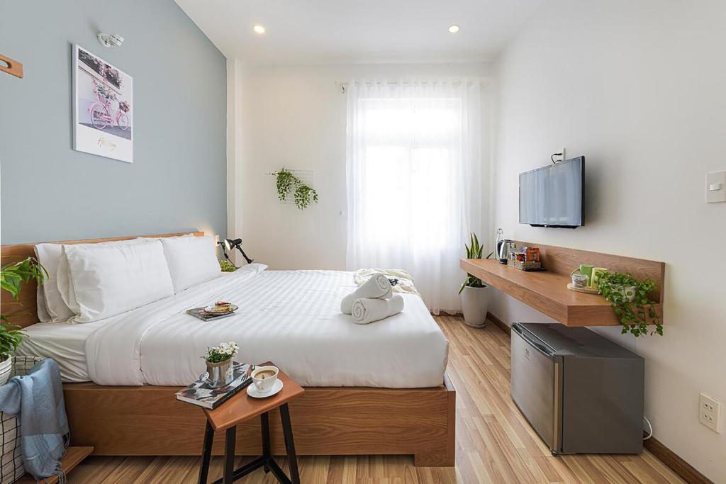 a bedroom with a large bed and a table at The Green House Da Lat in Da Lat