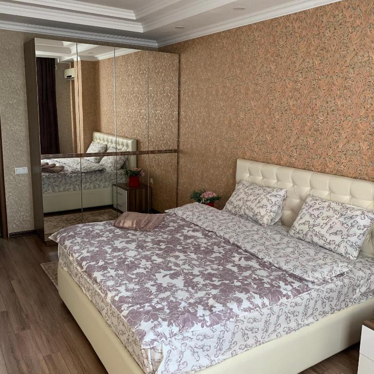 A bed or beds in a room at Apartment elit Bishkek