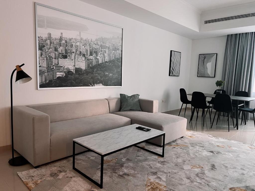 a living room with a couch and a table at Stylish 2 bdr in Dubai Marina & hotels beach access available in Dubai