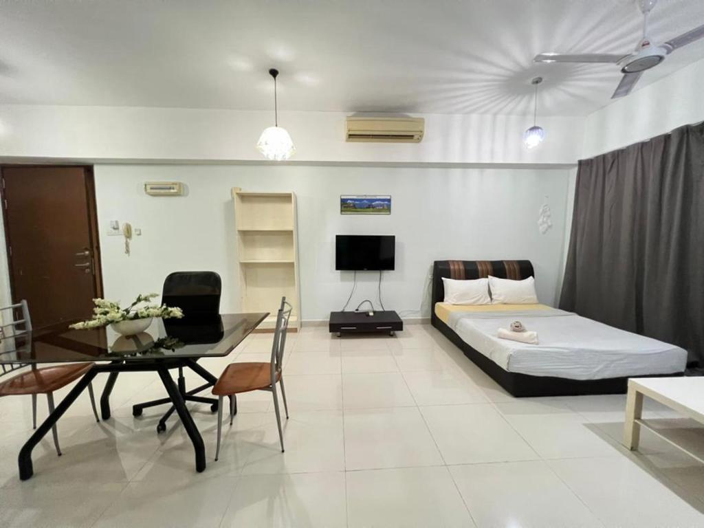 a bedroom with a bed and a table and a dining room at Family House in Kuala Lumpur