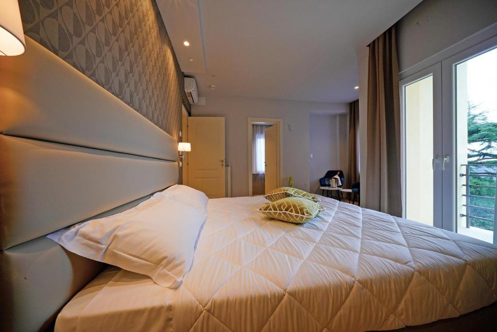 Postel nebo postele na pokoji v ubytování Hotel Valle del Fiora
