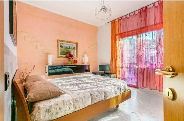 a bedroom with a large bed and a window at Camera Prestige in Rome