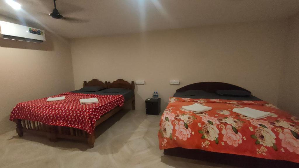 a room with two beds in a room at Palolem Cottages in Palolem