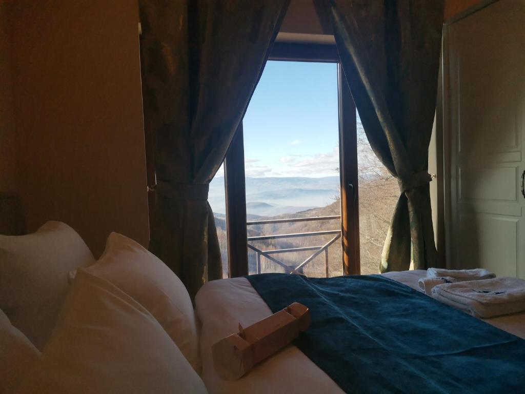 a bedroom with a bed with a view of a window at BELVEDERE A9 ( N LUX MILMARI RESORT) in Kopaonik
