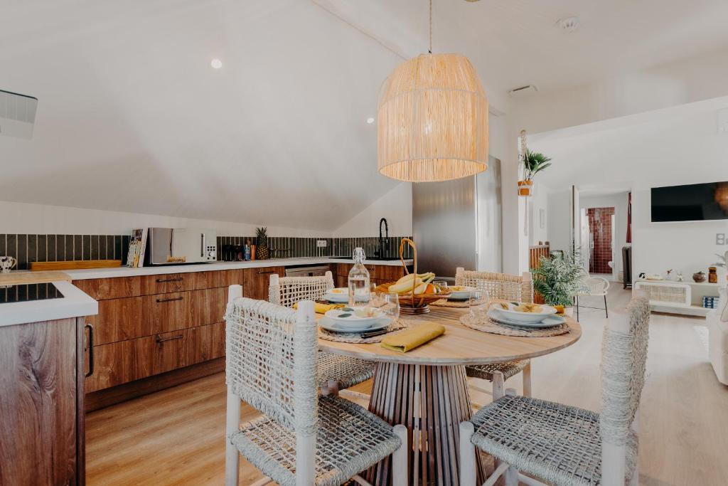 a kitchen and dining room with a table and chairs at Hôtel PALMITO in Biarritz