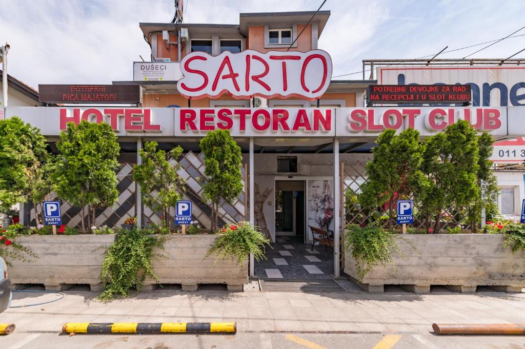 a hotel restaurant with a sign that reads santa hotel restroom club at Hotel Villa Sarto in Belgrade