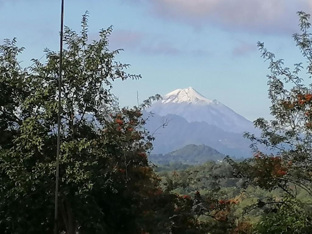 a mountain in the distance with trees in the foreground at El Abuelo in Xico
