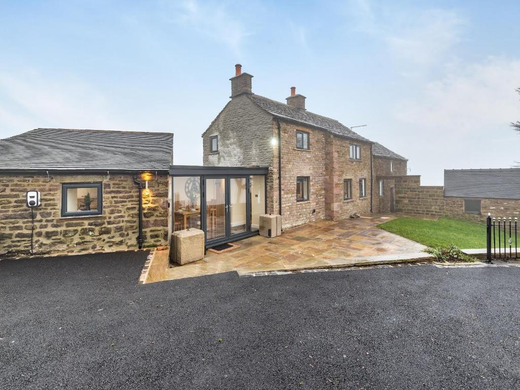 a large brick house with a large driveway at Headlands Farm in Flash