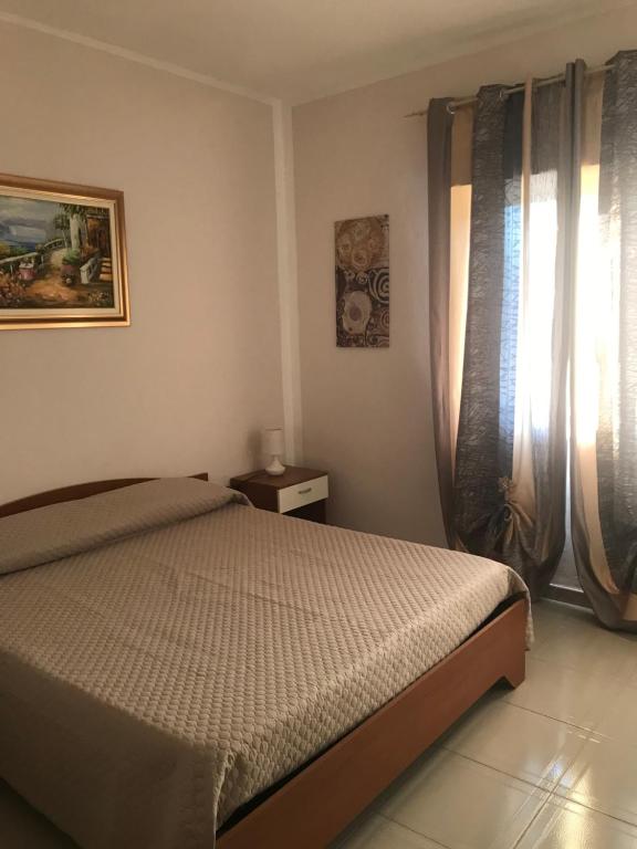 una camera da letto con un letto e una finestra di villa mediterranea a Realmonte