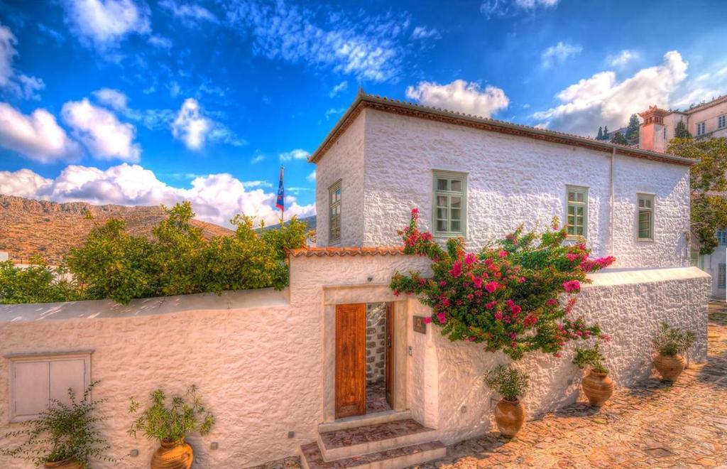 a white house with flowers on the side of it at Cotommatae Hydra 1810 in Hydra