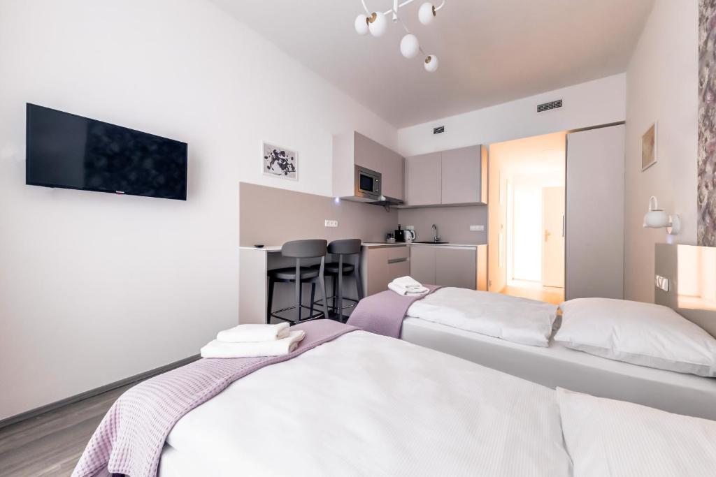 Postel nebo postele na pokoji v ubytování Kora Apartments