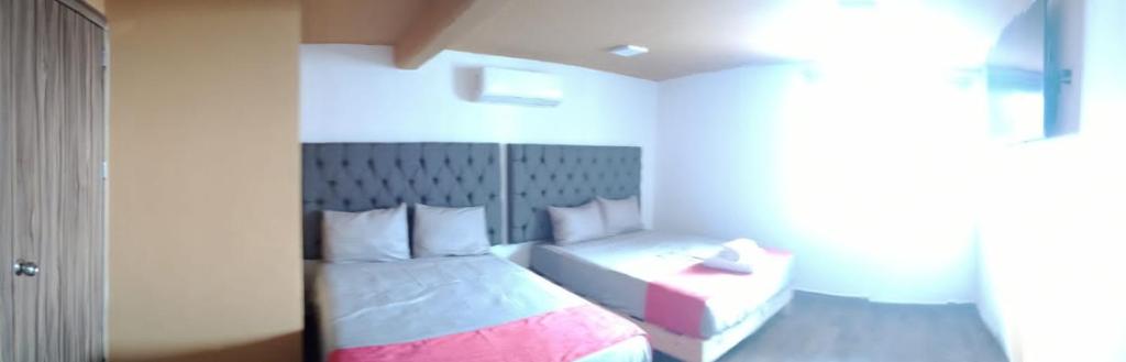 Postel nebo postele na pokoji v ubytování Hotel La Intimidad