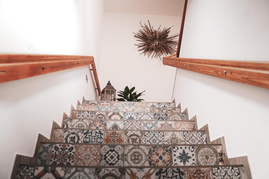a staircase with a tile floor and a plant at Pension Pohoda in Malá Morávka