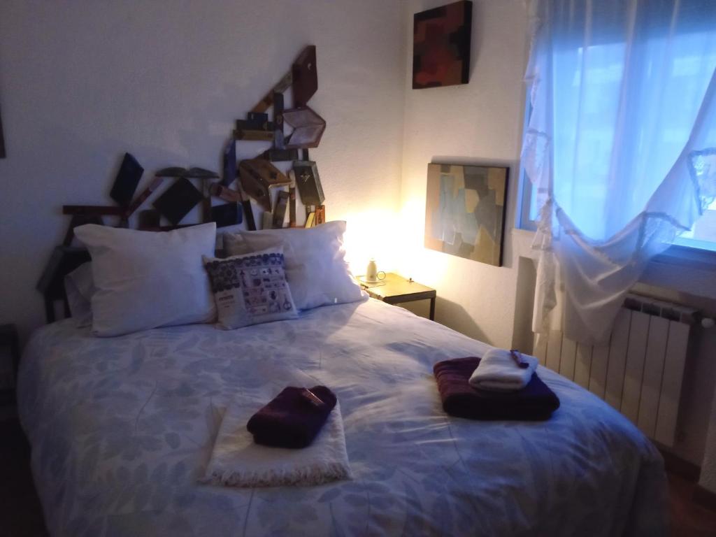 a bedroom with a bed with two towels on it at Warm and well connected in Madrid