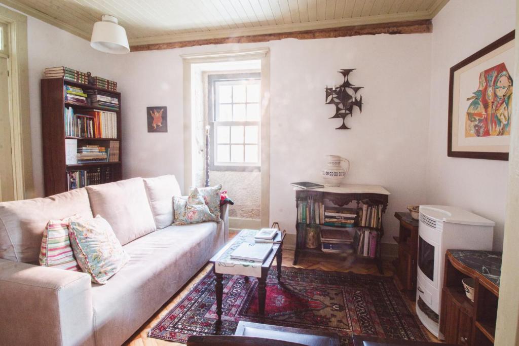 a living room with a couch and a table at Casa da Judiaria Velha in Viseu