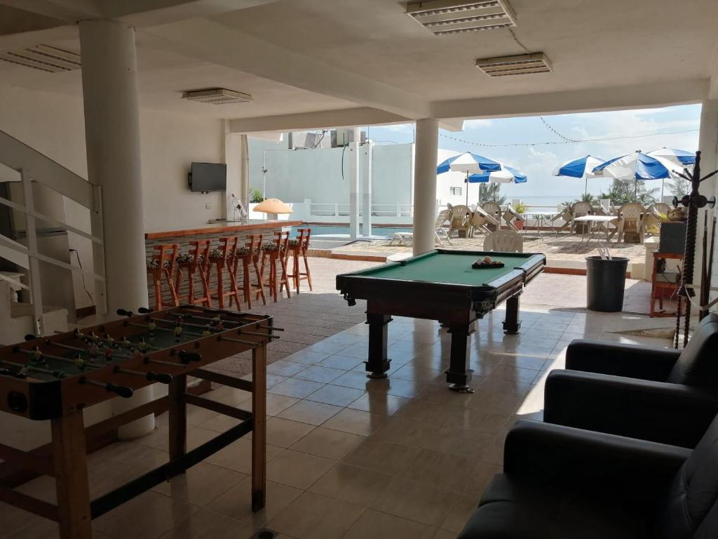 a living room with a pool table and chairs at Eventos punta Real in Chachalacas