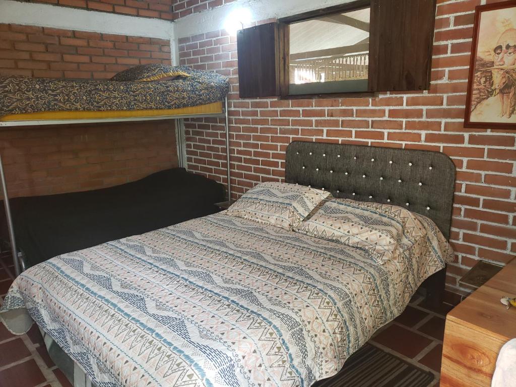 Postel nebo postele na pokoji v ubytování Hotel Campestre Villa Nico