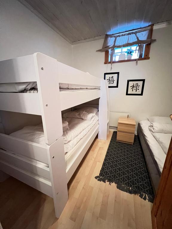 Norra Brändan في سالن: سرير أبيض بطابقين في غرفة بسريرين