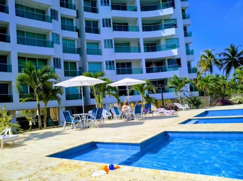 um resort com piscina e um edifício em Acogedor apartamento con vista al mar en coveñas em Coveñas