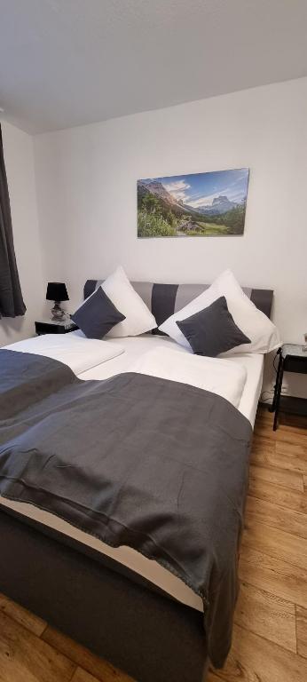a bedroom with a large bed and a painting on the wall at Waterfalls Apartment 2 in Triberg
