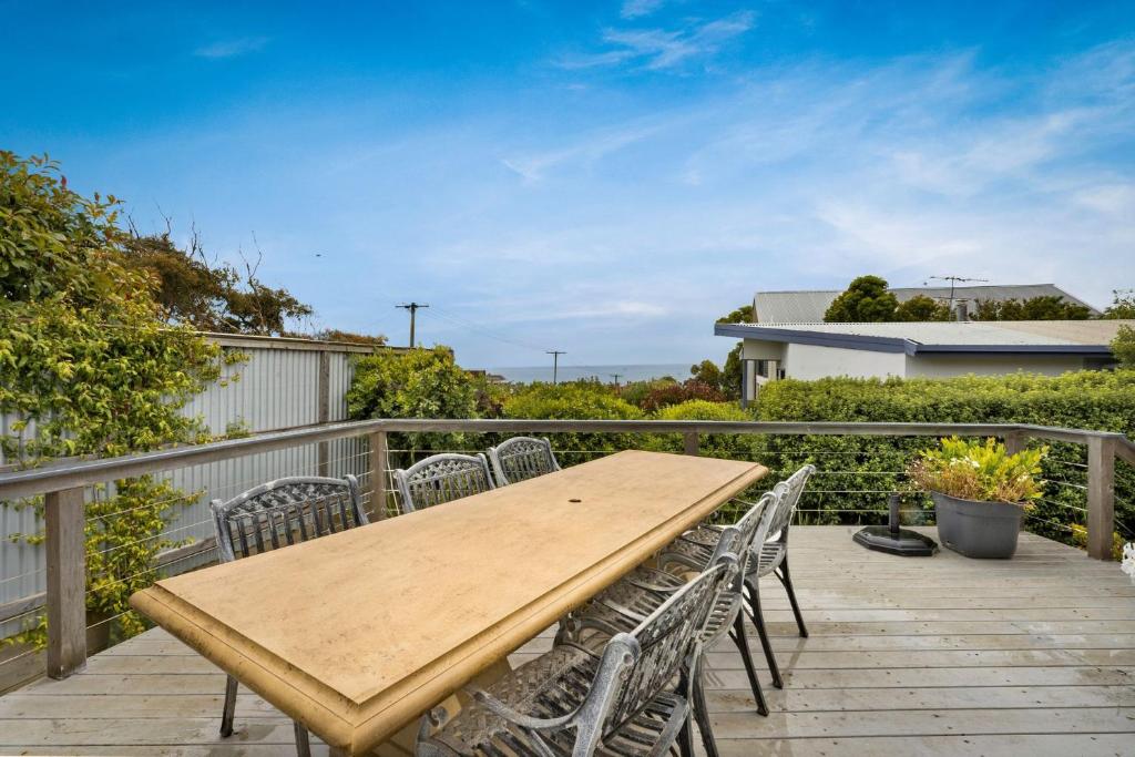 a wooden table and chairs on a deck at Bayview Cottage in Ventnor