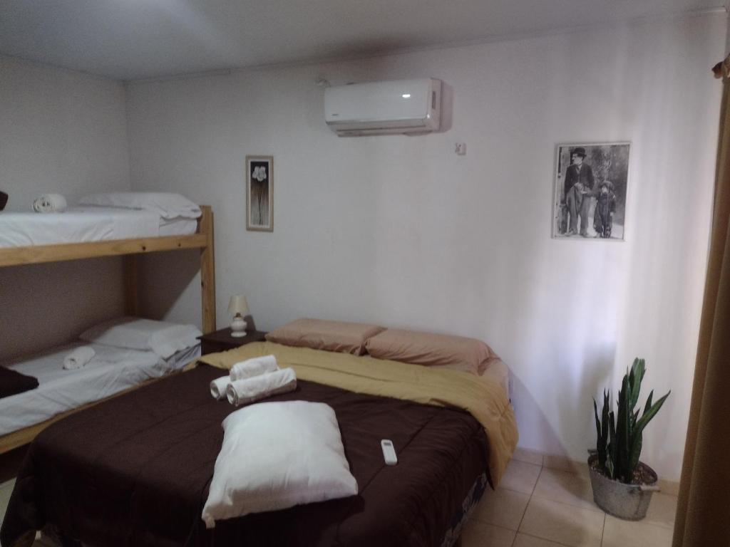 a room with two beds with towels on them at ESPACIO CANELA in Ramallo