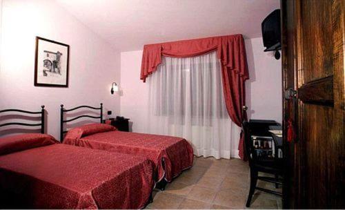 Postel nebo postele na pokoji v ubytování Dominus Hotel