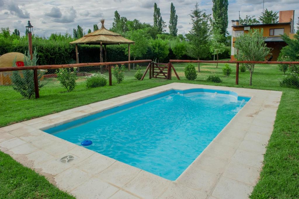 a swimming pool in the yard of a house at Complejo BenjaLuna in San Rafael