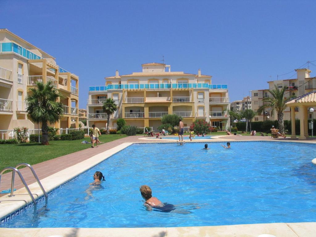 a group of people in a swimming pool in a resort at La Riviera - Serviden in Denia