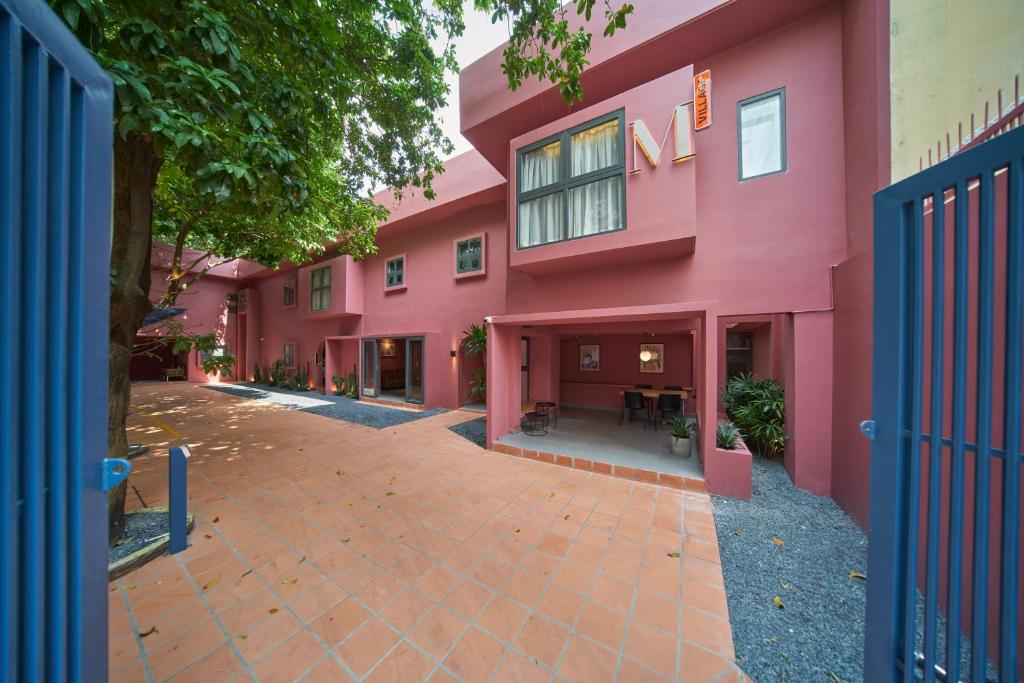 a pink building with a courtyard in front of it at M Village Hồ Biểu Chánh in Ho Chi Minh City