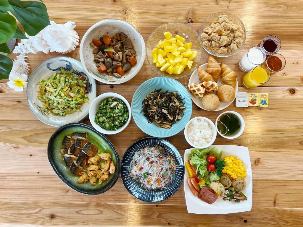 a wooden table topped with bowls of different types of food at Hotel Abest Naha Kokusaidori in Naha