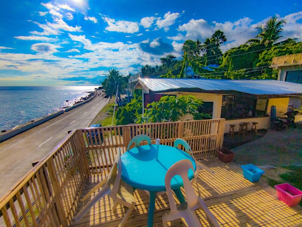 a balcony with a table and chairs and the ocean at Truth be Found Ministry Resort in Jagna