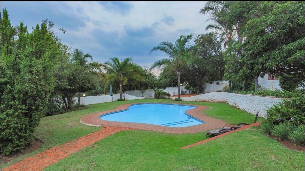 a swimming pool in the middle of a yard at The Oasis in Hartbeespoort