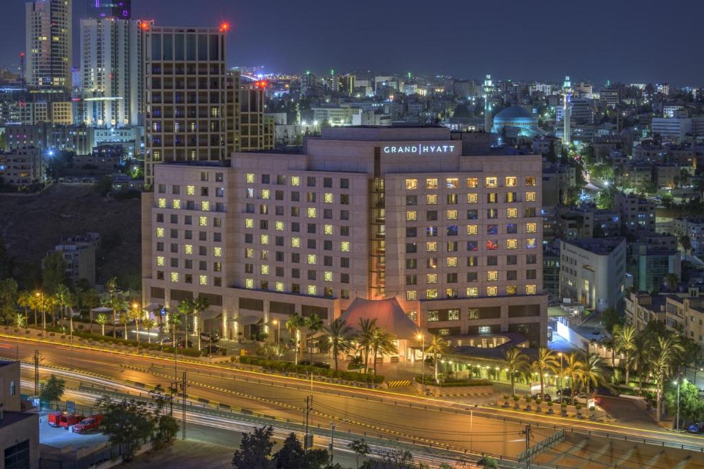 a view of a city at night with buildings at Grand Hyatt Amman in Amman