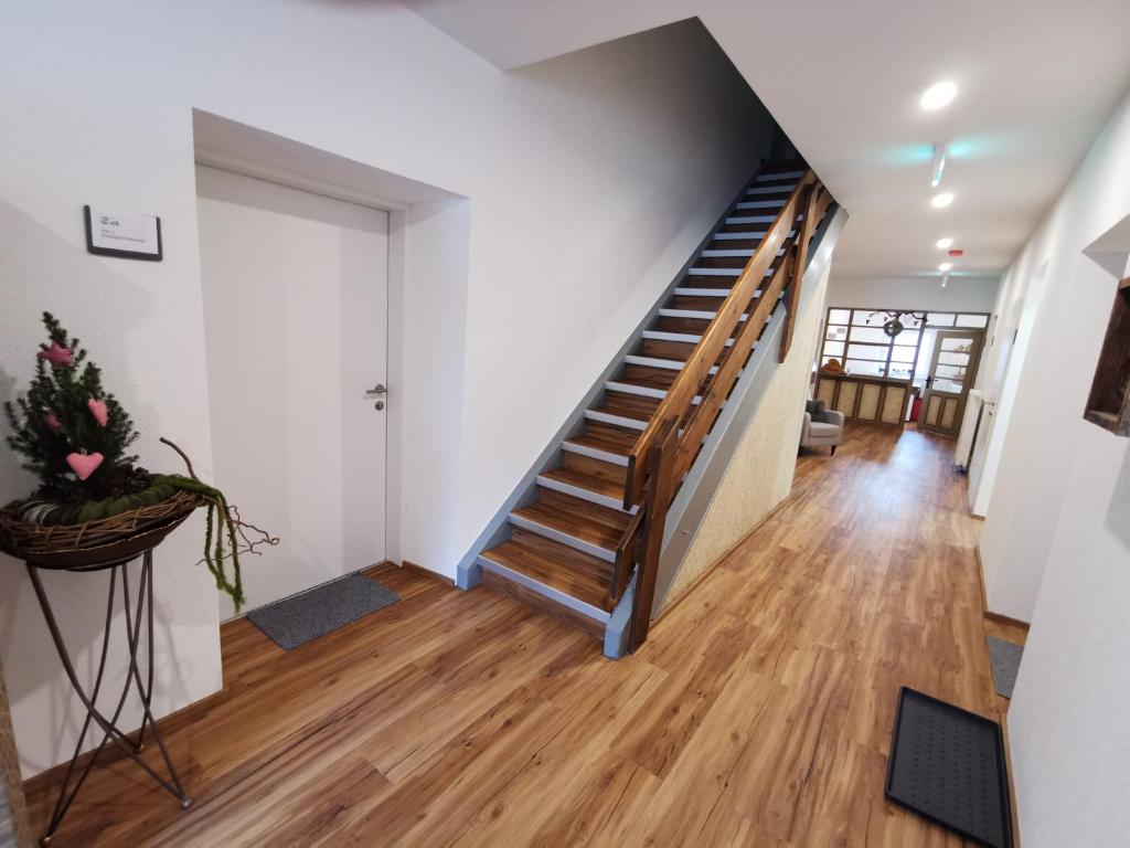 a staircase in a home with wooden floors at Apartments HAUS SCHÖN - Preise inclusive Pitztal Sommer Card in Jerzens