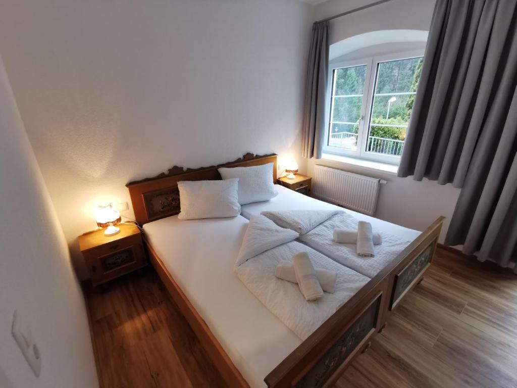 a bedroom with a bed with two pillows on it at Apartments HAUS SCHÖN - Preise inclusive Pitztal Sommer Card in Jerzens