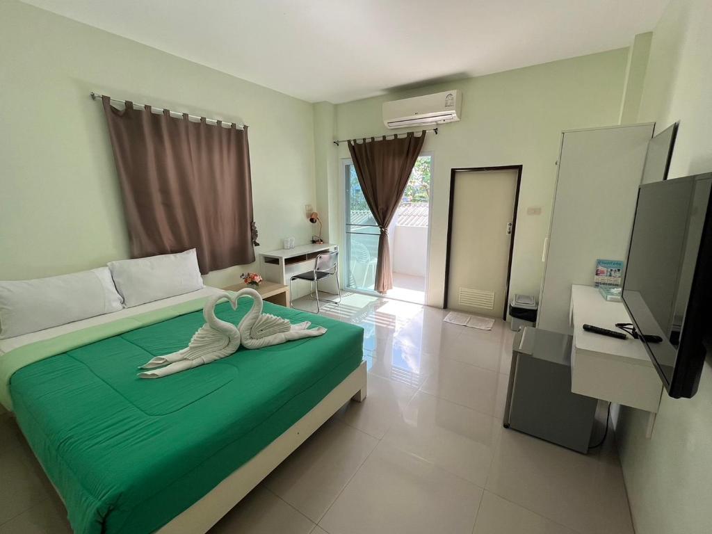 Postel nebo postele na pokoji v ubytování Papangkorn House