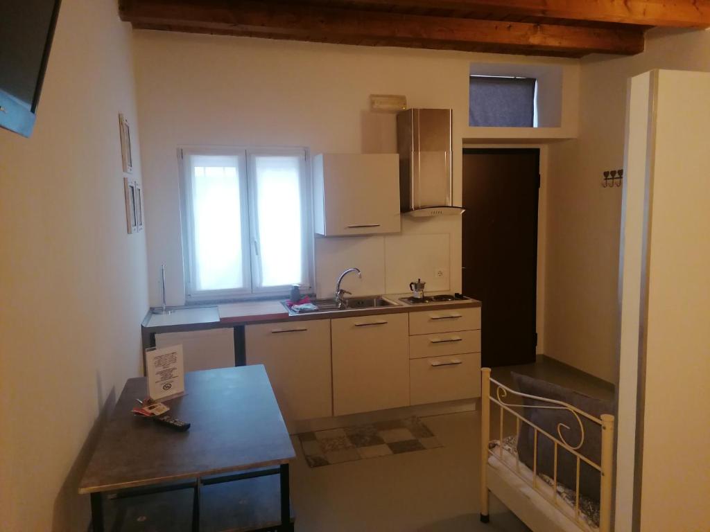 a small kitchen with a sink and a window at A New Guesthouse in Pavia