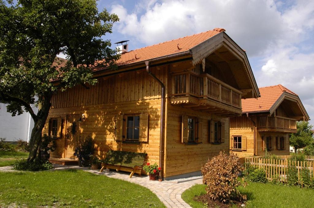 a wooden house with a bench in front of it at Ferienhaus Lenzenbauer in Salzburg