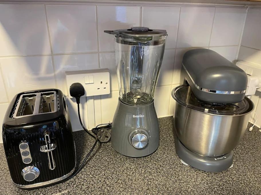 a blender sitting on a counter next to a processor at Self-catering fully equipped apartment in Vauxhall in London