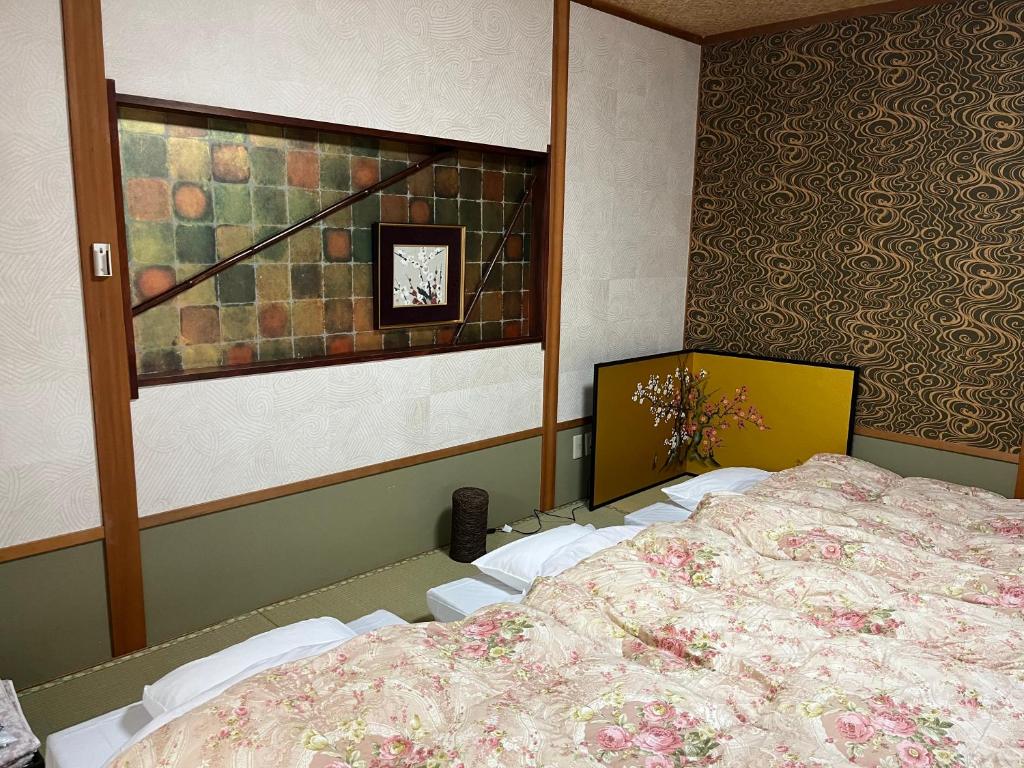 Postel nebo postele na pokoji v ubytování Kyoto Ryokan Gion Sano