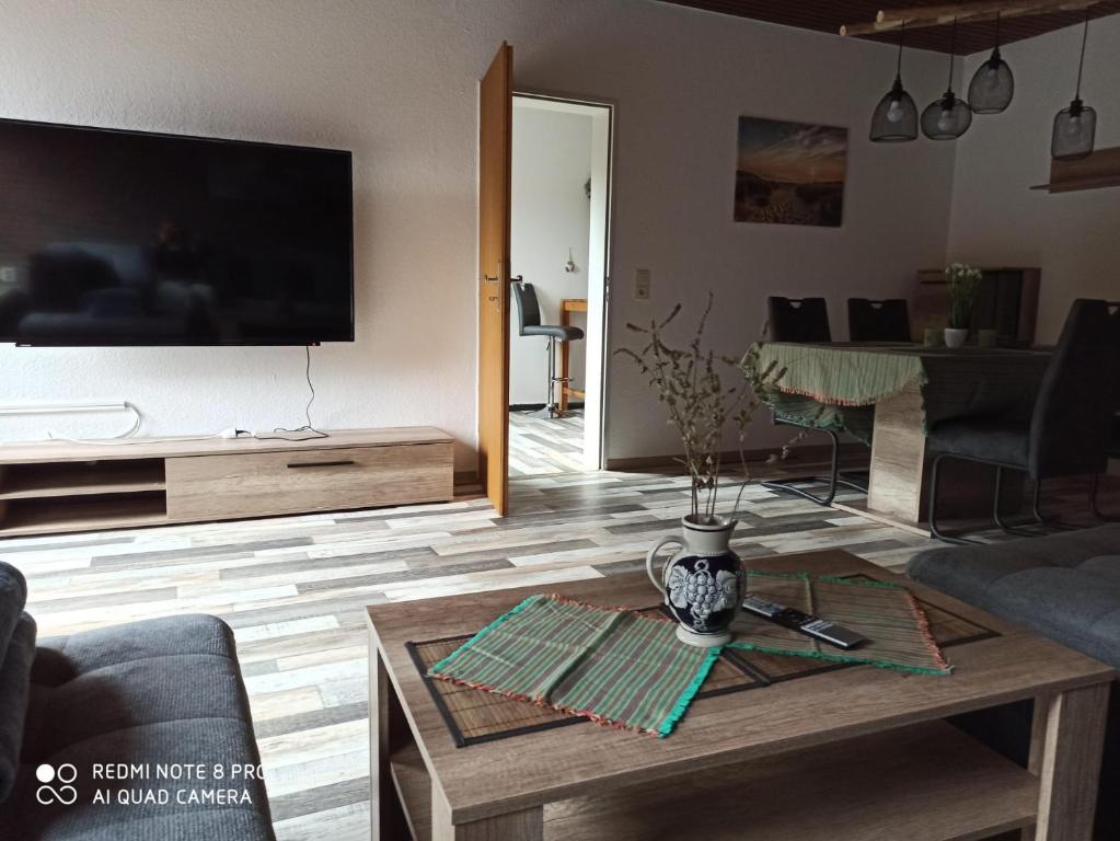 a living room with a tv and a coffee table at Nordlicht in Schortens