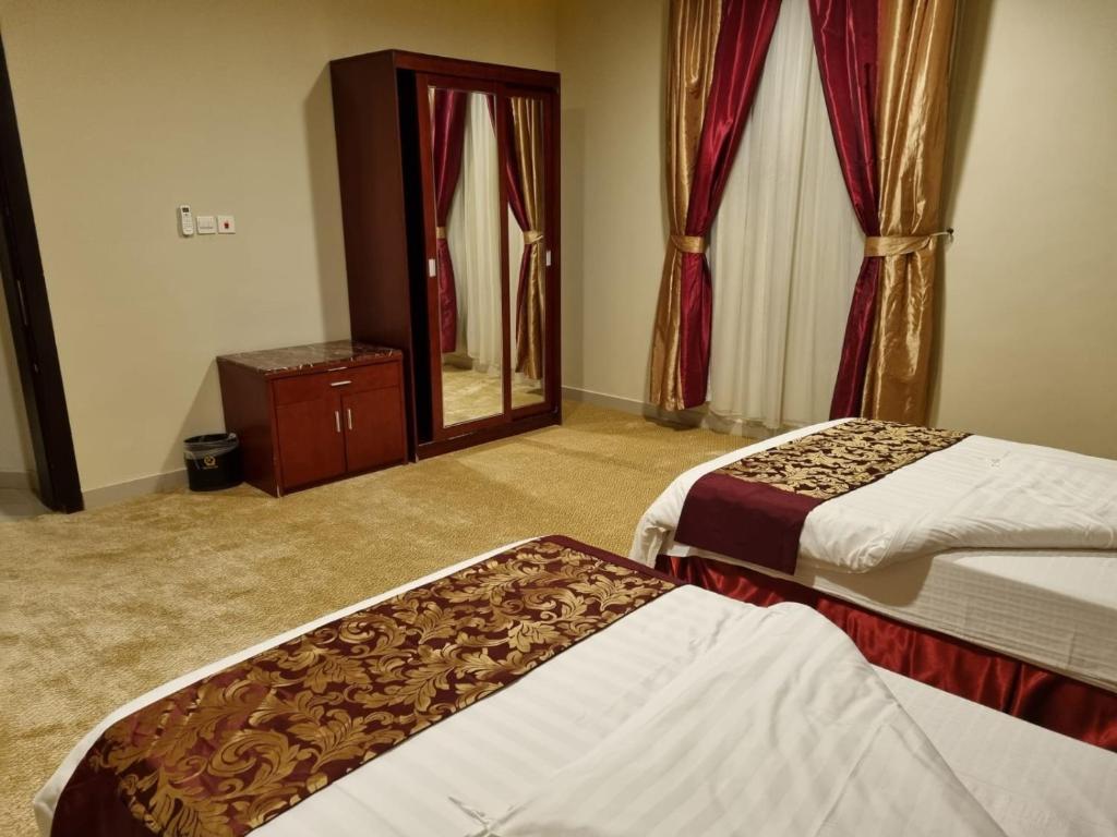Postel nebo postele na pokoji v ubytování رؤوم ان للشقق الفندقية-Raoum Inn Hotel Apartments