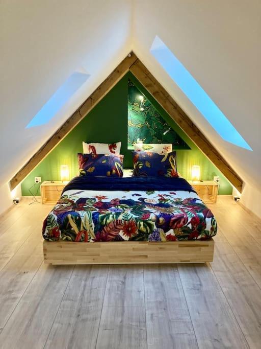 Hotel Les Toits d'Austerlitz, a bedroom with a bed in the attic at Les Toits d'Austerlitz in Strasbourg